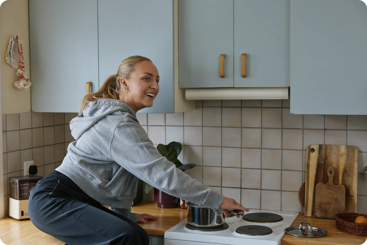 Someone cooking in a kitchen at home